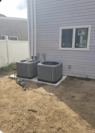 Side-by-side central AC units on concrete pad